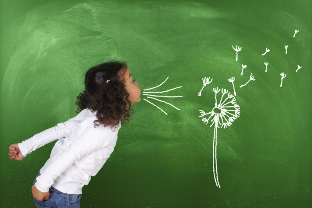schoolgirl-blowing-a-drawing-of-dandelion-on-blackboard
