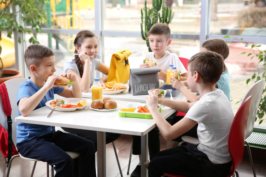 school-children-enjoying-lunch-at-a-cafeteria-table