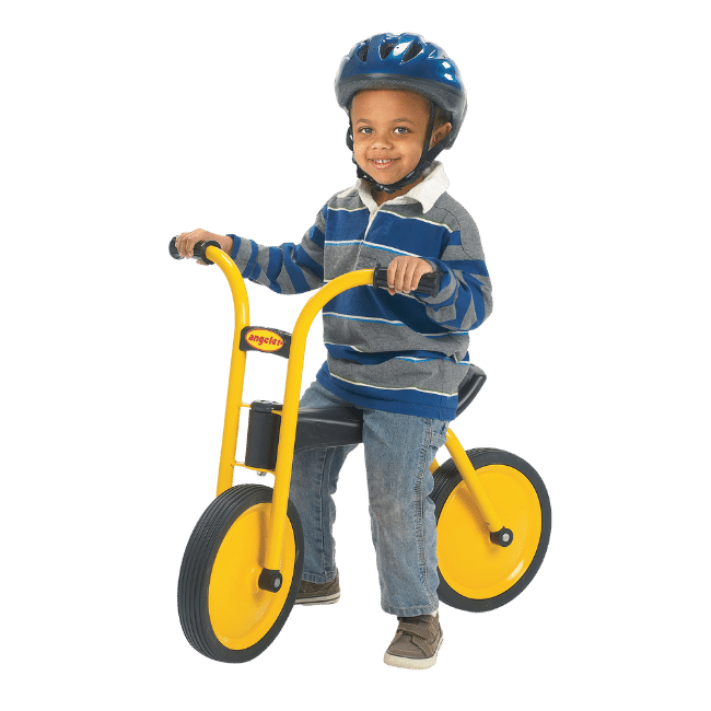 Worthington Direct Young preschooler riding on a balance bike.